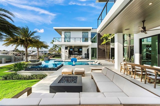 a bathroom with double vanity sinks a large mirror and a shower