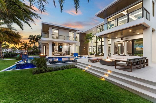 a living room with furniture and large windows