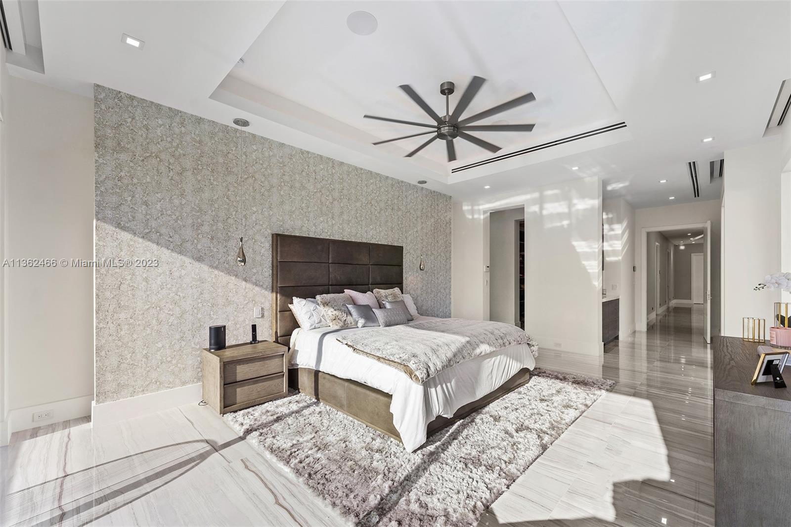 3101 Northeast 27th Avenue Lighthouse Point, FL 33064 - Photo 37 of 78 a bedroom with a large bed and a chandelier