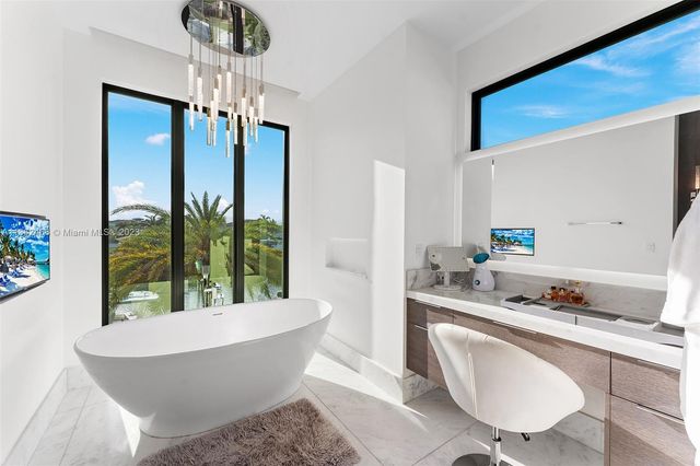 a view of swimming pool with a table and chairs couches and a fire pit