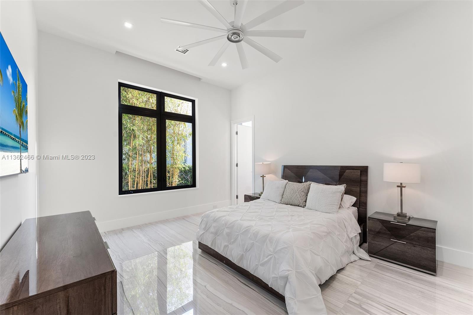 3101 Northeast 27th Avenue Lighthouse Point, FL 33064 - Photo 45 of 78 a bedroom with a bed and window