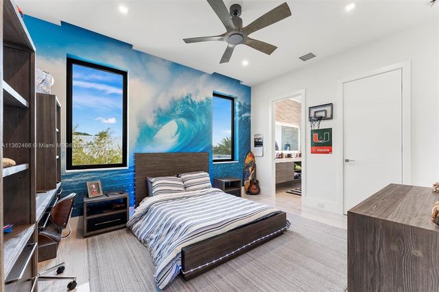 a front view of a house with a garden and fountain