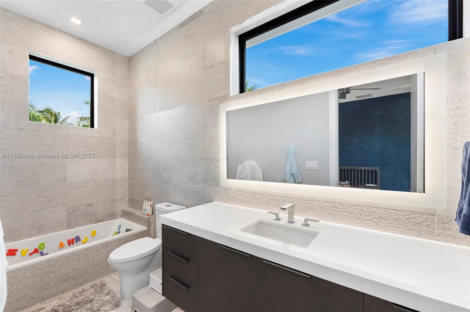 3101 Northeast 27th Avenue Lighthouse Point, FL 33064 - Photo 50 of 78 a bathroom with a sink a toilet and a bathtub