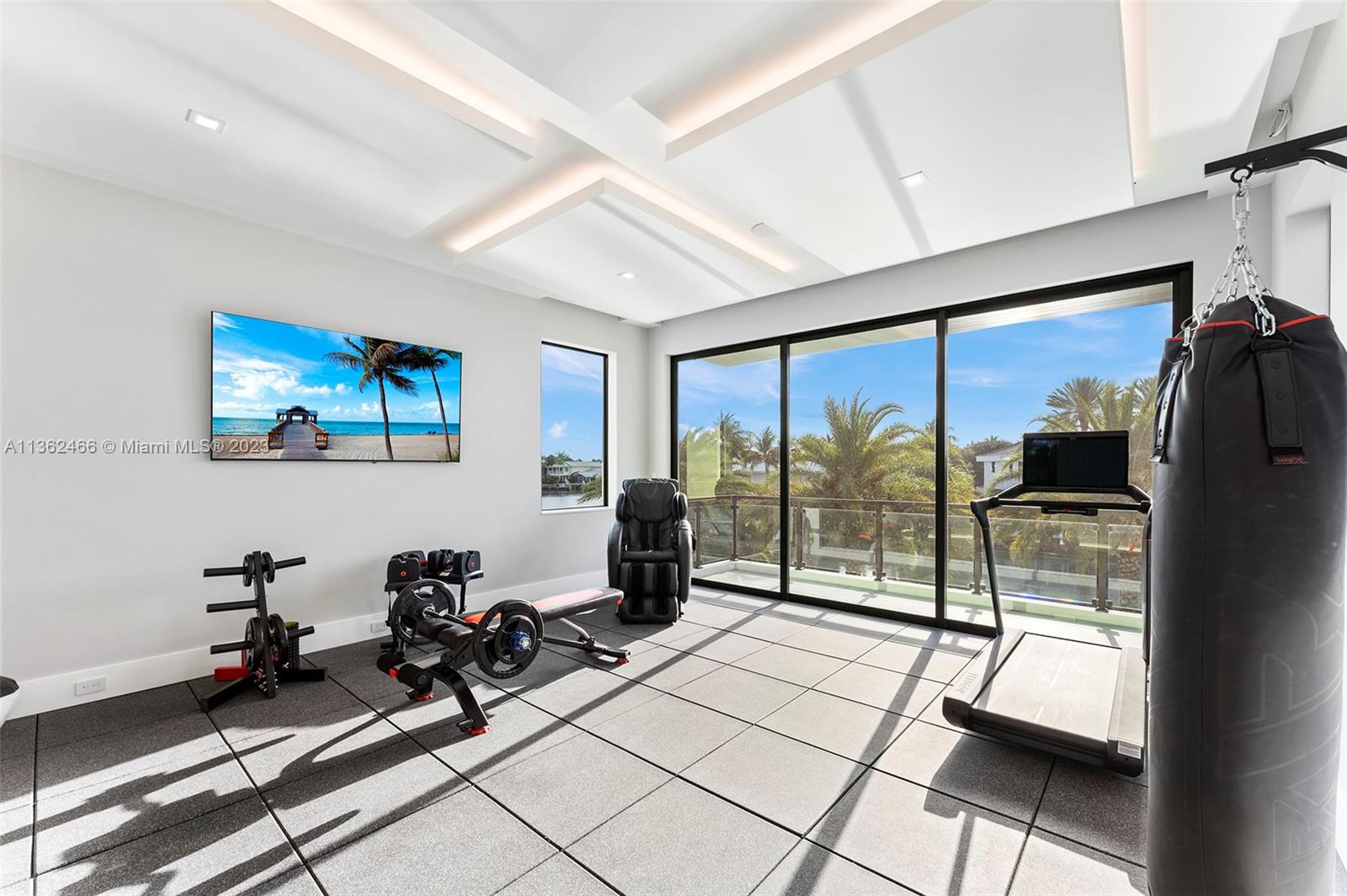 3101 Northeast 27th Avenue Lighthouse Point, FL 33064 - Photo 55 of 78 a room with gym equipment and floor to ceiling window