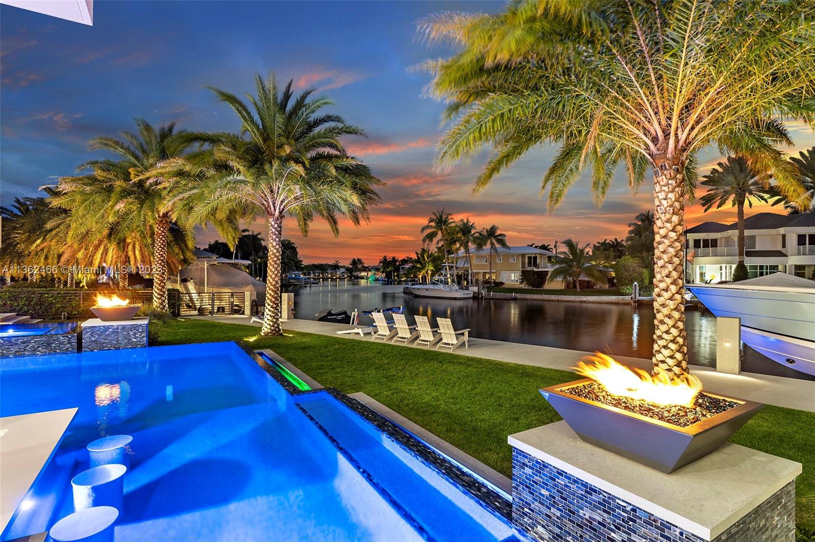3101 Northeast 27th Avenue Lighthouse Point, FL 33064 - Photo 64 of 78 a view of swimming pool with a table and chairs couches and a fire pit