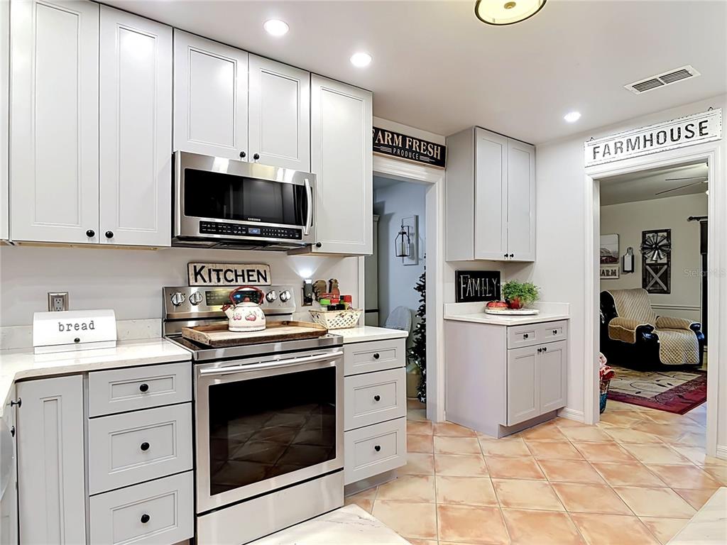 1395 Maytown Road Osteen, FL 32764 - Photo 22 of 65 a kitchen with white cabinets and appliances