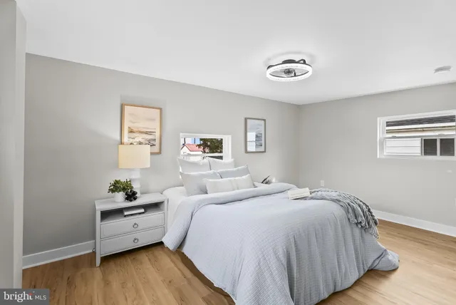 a bedroom with a bed and a wooden floor