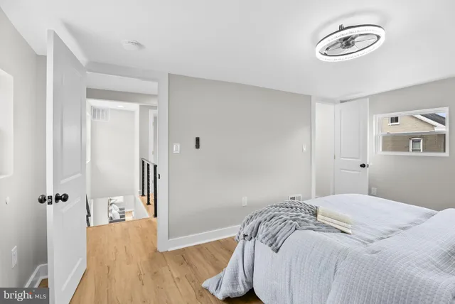 a bedroom with a bed and a wooden floor