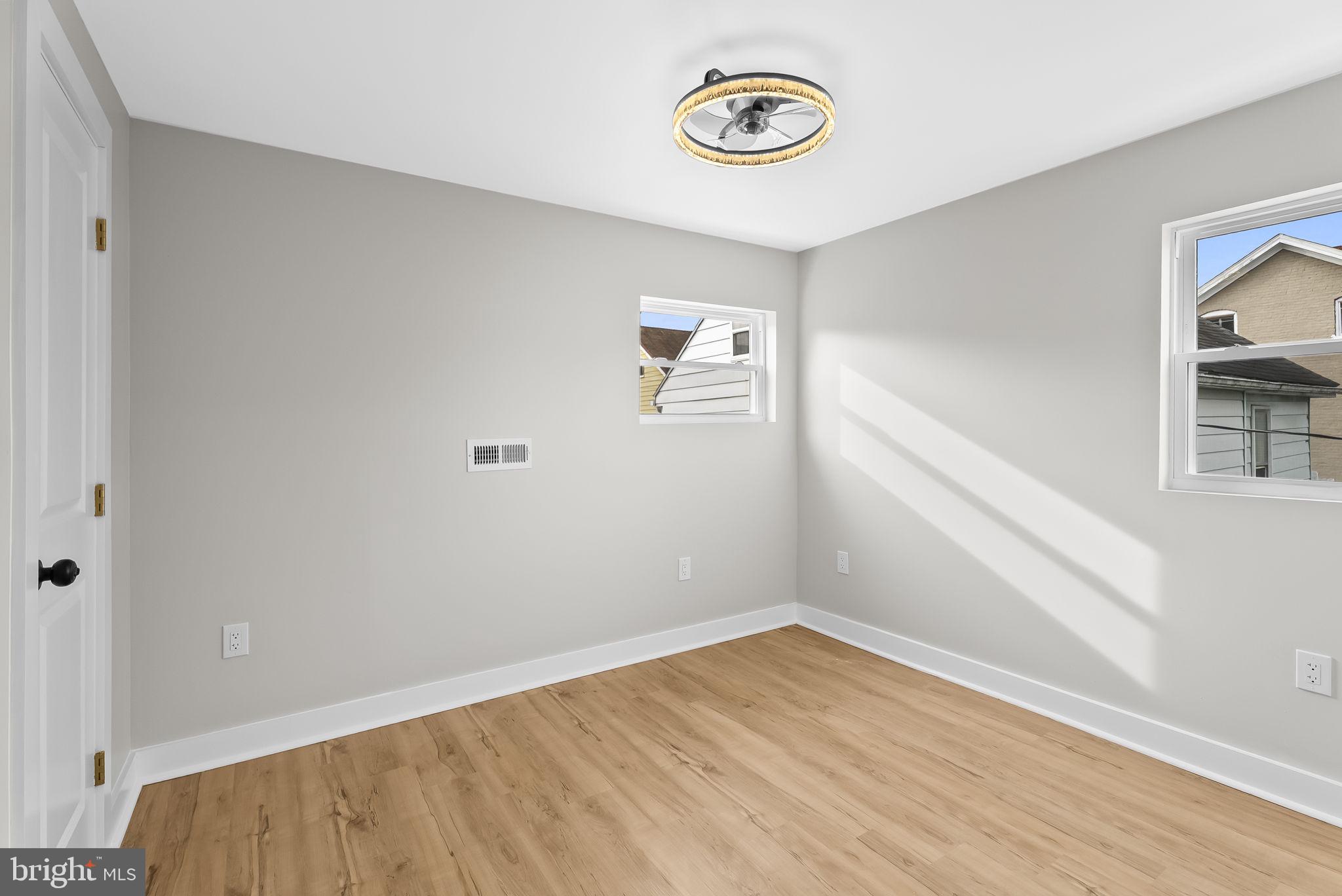 432 Cook Street Hagerstown, MD 21740 - Photo 14 of 22 an empty room with a window and wooden floor