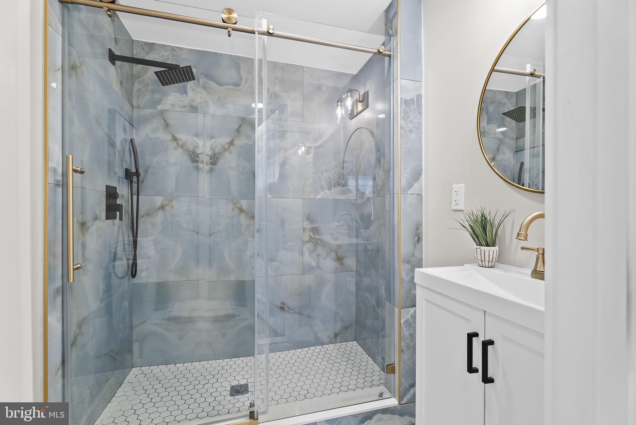 432 Cook Street Hagerstown, MD 21740 - Photo 17 of 22 a bathroom with a shower a mirror and a sink