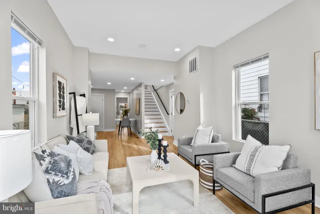 a living room with furniture and a potted plant