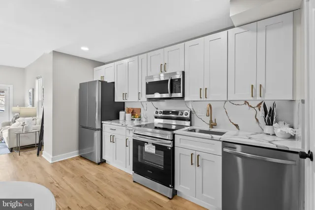 a kitchen with a sink stove and refrigerator