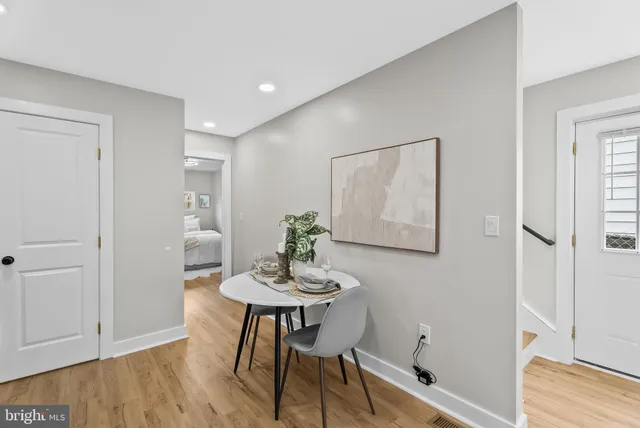 a view of a room with furniture and wooden floor