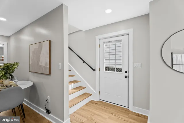 a view of a hallway with entryway wooden floor and front door
