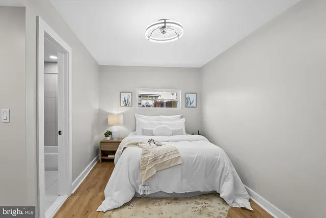 a bedroom with a bed and a window