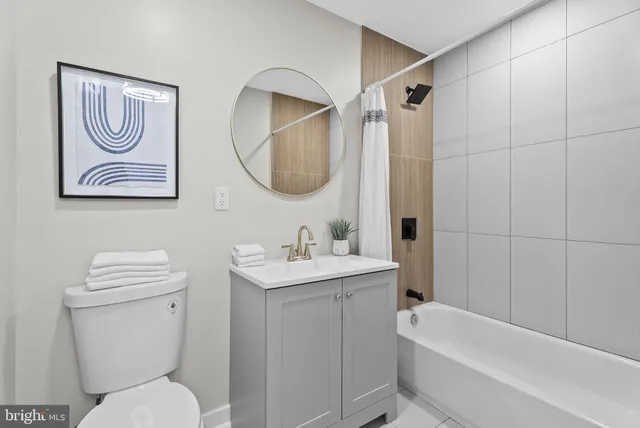 a bathroom with a toilet a sink and a mirror