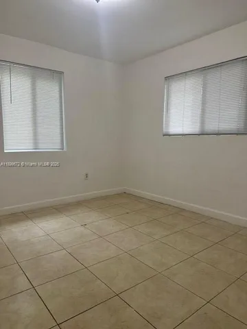 a view of a room with white tiles