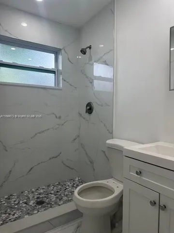 a bathroom with a toilet and a shower