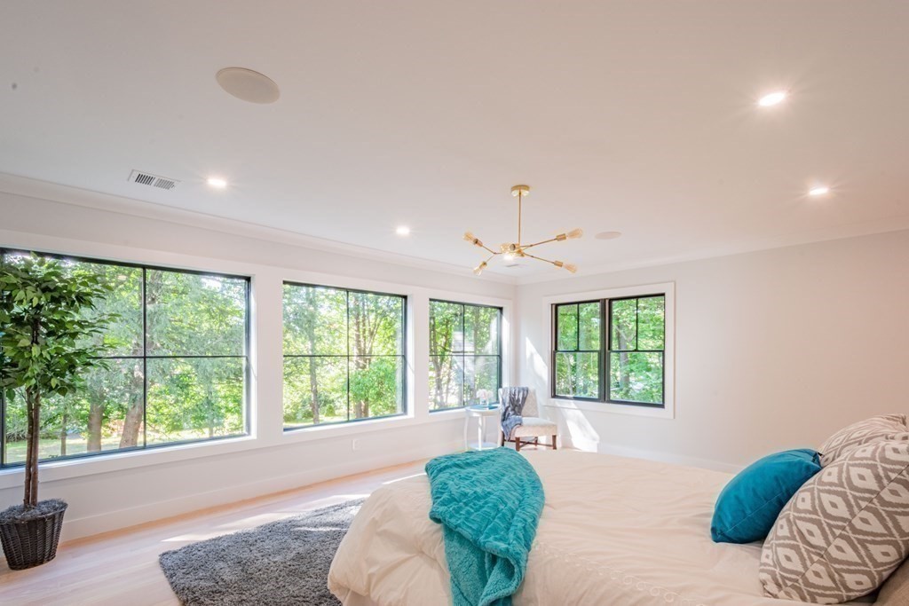 5 Kimball Road Lexington, MA 02421 - Photo 23 of 42 a spacious bedroom with a large bed and a large window