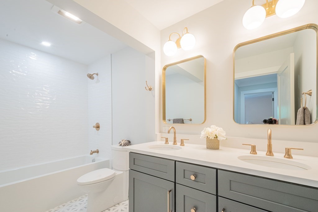 5 Kimball Road Lexington, MA 02421 - Photo 28 of 42 a bathroom with a sink a toilet and a large mirror