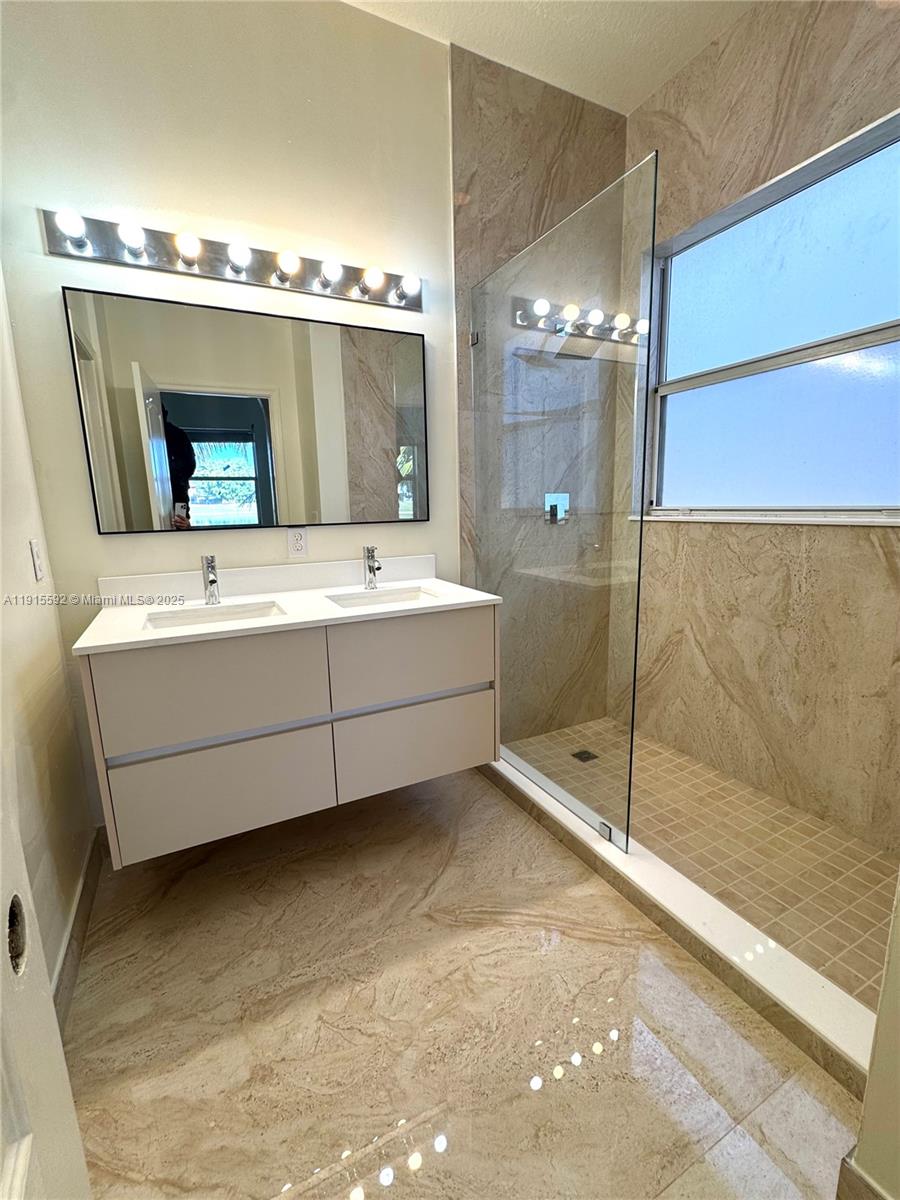 3725 Northeast 23rd Court Homestead, FL 33033 - Photo 15 of 25 a bathroom with a tub sink shower and mirror