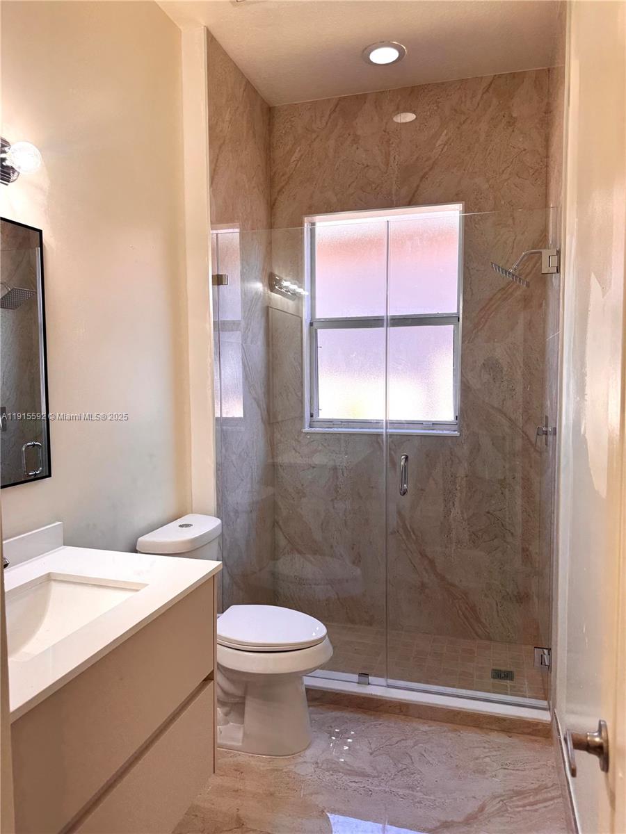 3725 Northeast 23rd Court Homestead, FL 33033 - Photo 18 of 25 a bathroom with a toilet a sink and shower