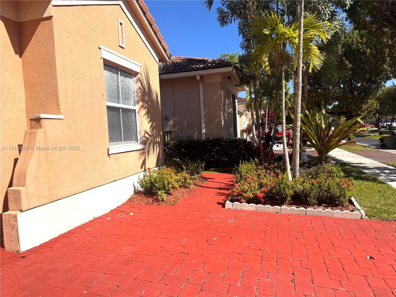 3725 Northeast 23rd Court Homestead, FL 33033 - Photo 2 of 25 a front view of a house with a yard