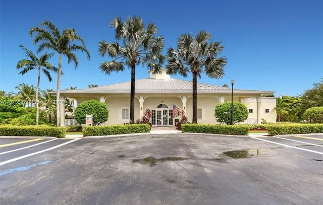 a front view of a house with a garden and a yard