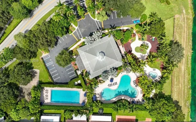 an aerial view of a house with a yard and garden