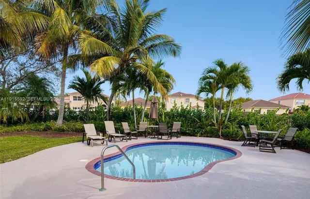a view of a swimming pool with a table and chairs