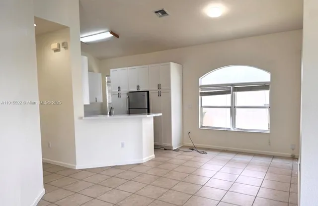 a kitchen with a sink cabinets and utility