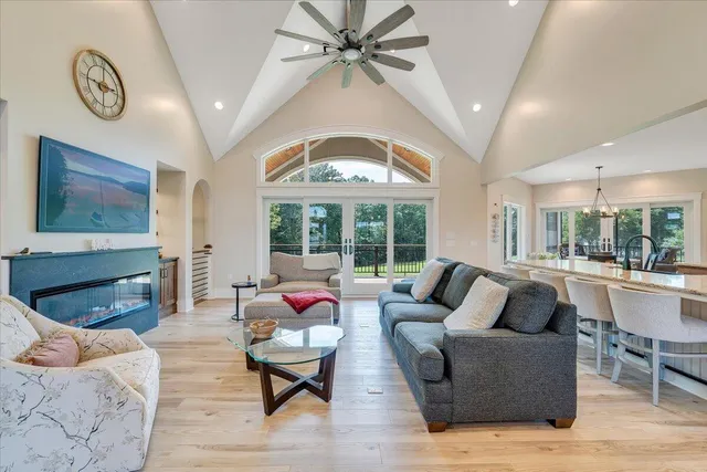 a large kitchen with stainless steel appliances kitchen island granite countertop a large counter top and wooden floors