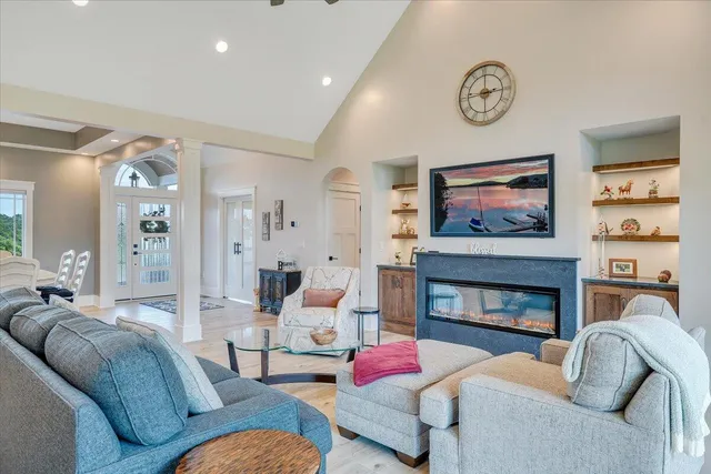a dining room with furniture a chandelier and window