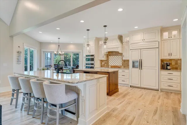 a bathroom with a granite countertop toilet sink and mirror