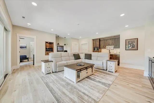 an aerial view of residential houses with outdoor space and trees