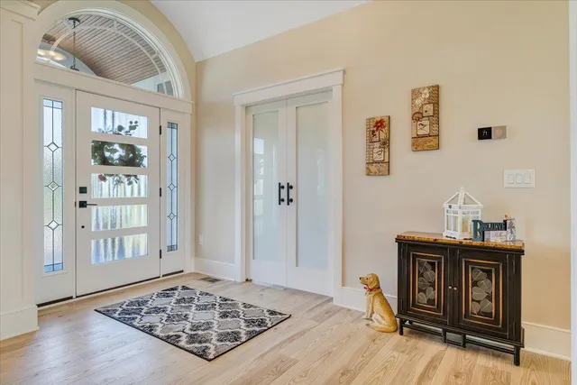 a living room with furniture a large window and a chandelier