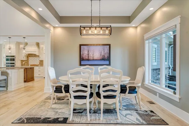 a living room with fireplace furniture and a large window