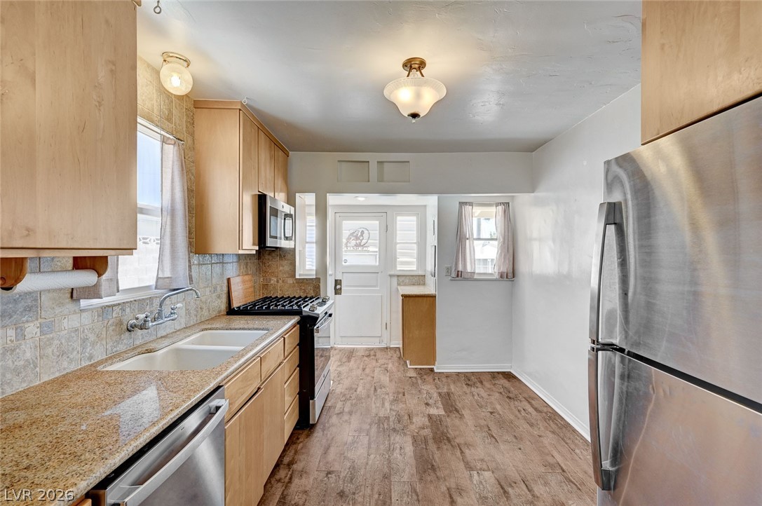 629 L Avenue Boulder City, NV 89005 - Photo 13 of 46 Kitchen: light wood finish cabinets, stainless steel appliances, granite countertops, custom backsplash