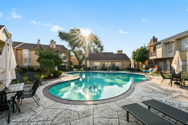 a view of a swimming pool with a patio