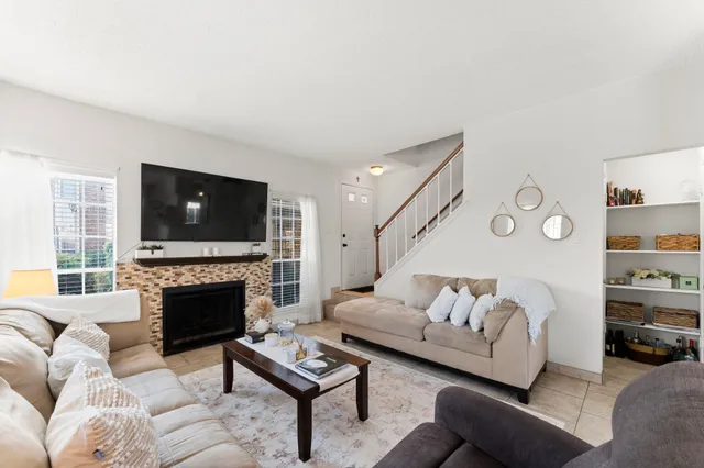 a living room with furniture flat screen tv and a fireplace