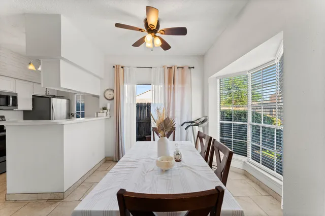 a dining room with furniture and a window