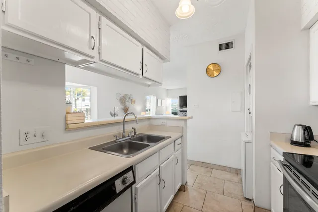 a kitchen with a sink cabinets and appliances
