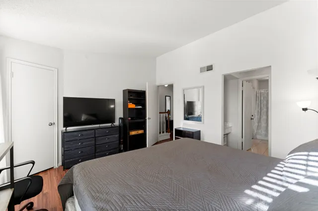 a bedroom with a bed and a flat screen tv