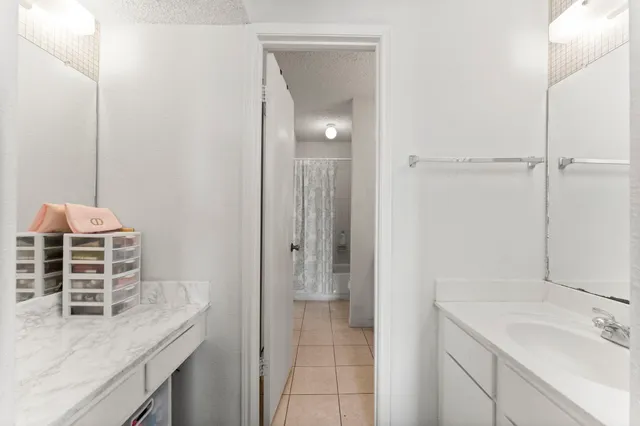 a bathroom with a granite countertop sink and mirror
