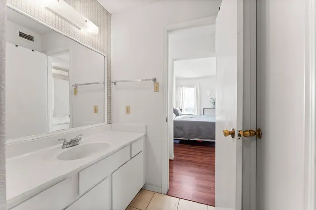 a en suite bathroom with a sink a mirror and a shower