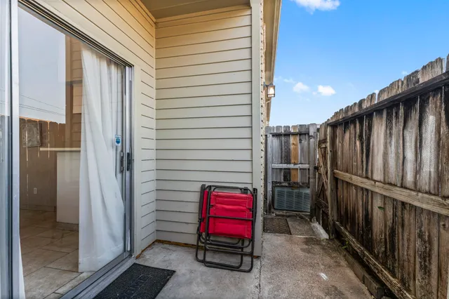 a view of a door and chair in the balcony