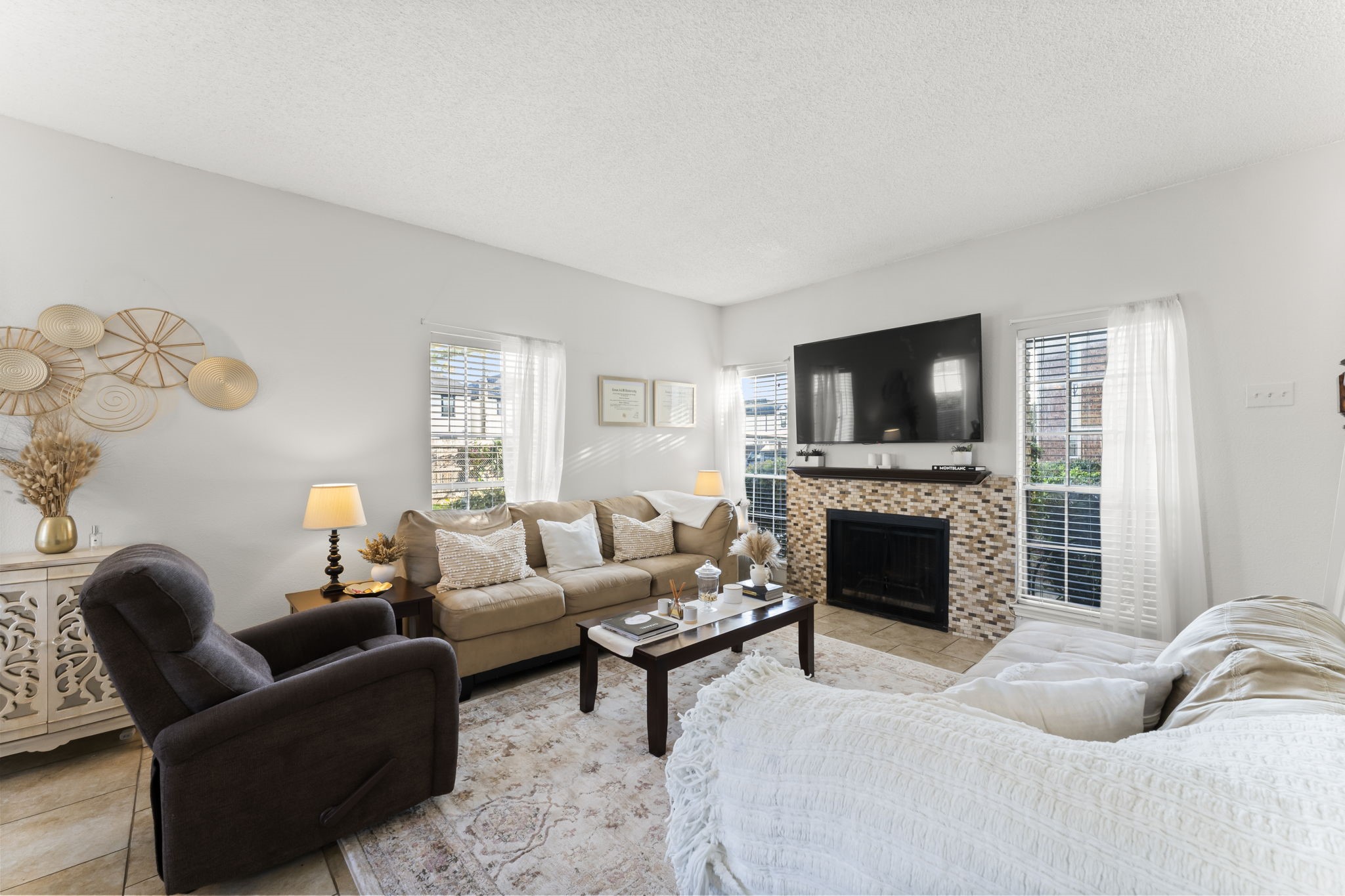 3600 Jeanetta Street, Unit 605 Houston, TX 77063 - Photo 9 of 29 a living room with furniture a fireplace and a flat screen tv