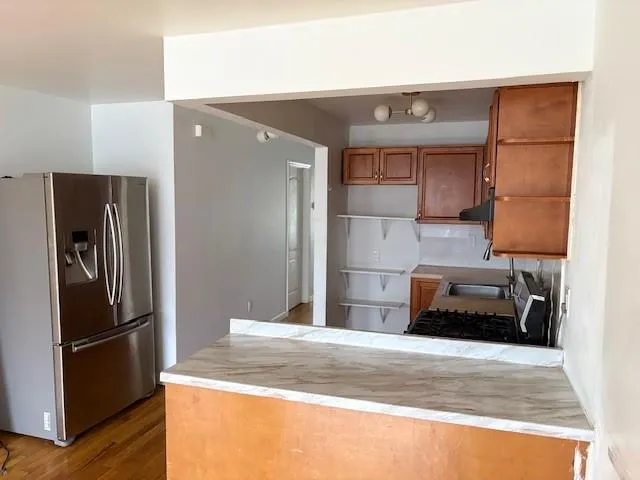 a kitchen with a refrigerator and a sink