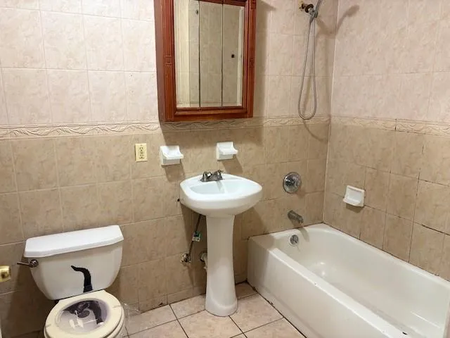 a bathroom with a sink a toilet and bathtub