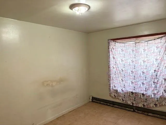 a room with water heater and a window